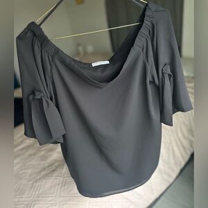 Aritzia- Babaton Black Off-Shoulder Blouse with tie detail on the sleeves.